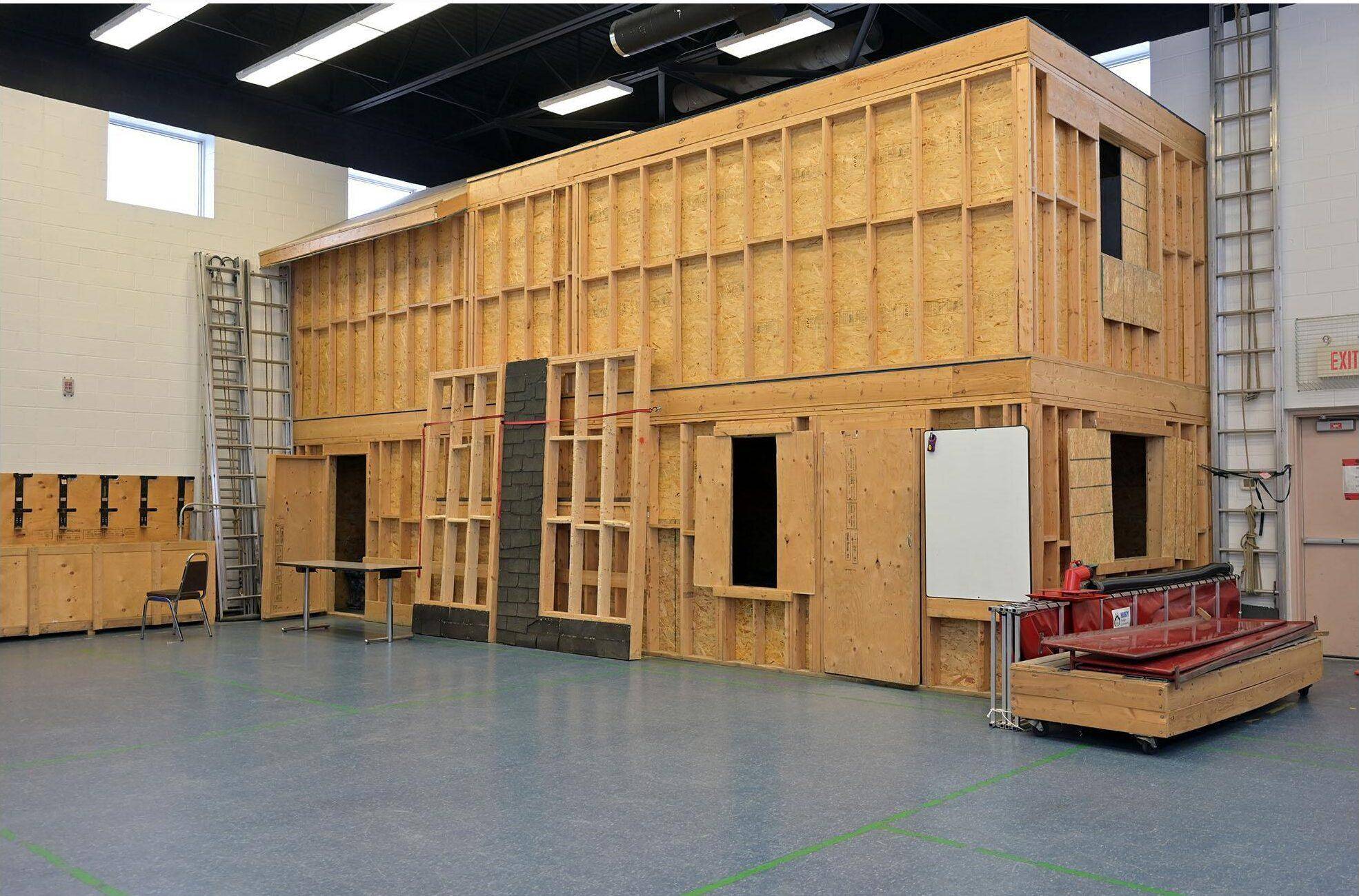 Indoor training facility with a wood-frame residential structure and equipment