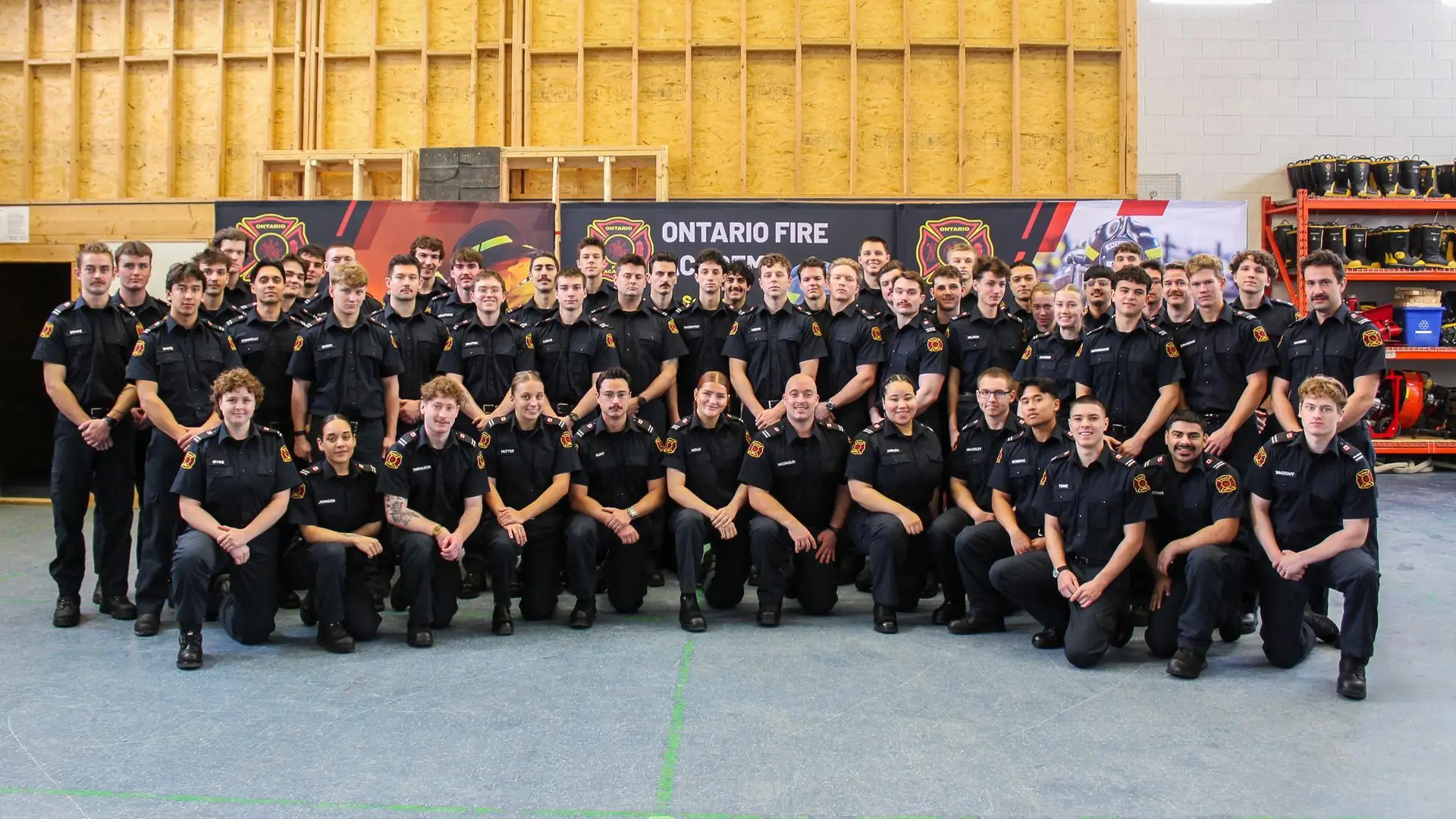 Group photo of Ontario Fire Academy students and staff kneeling together