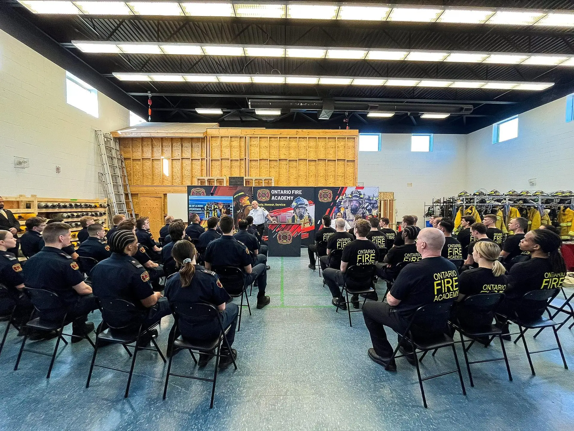 Ontario Fire Academy students attending an orientation session inside the firefighter training facility.