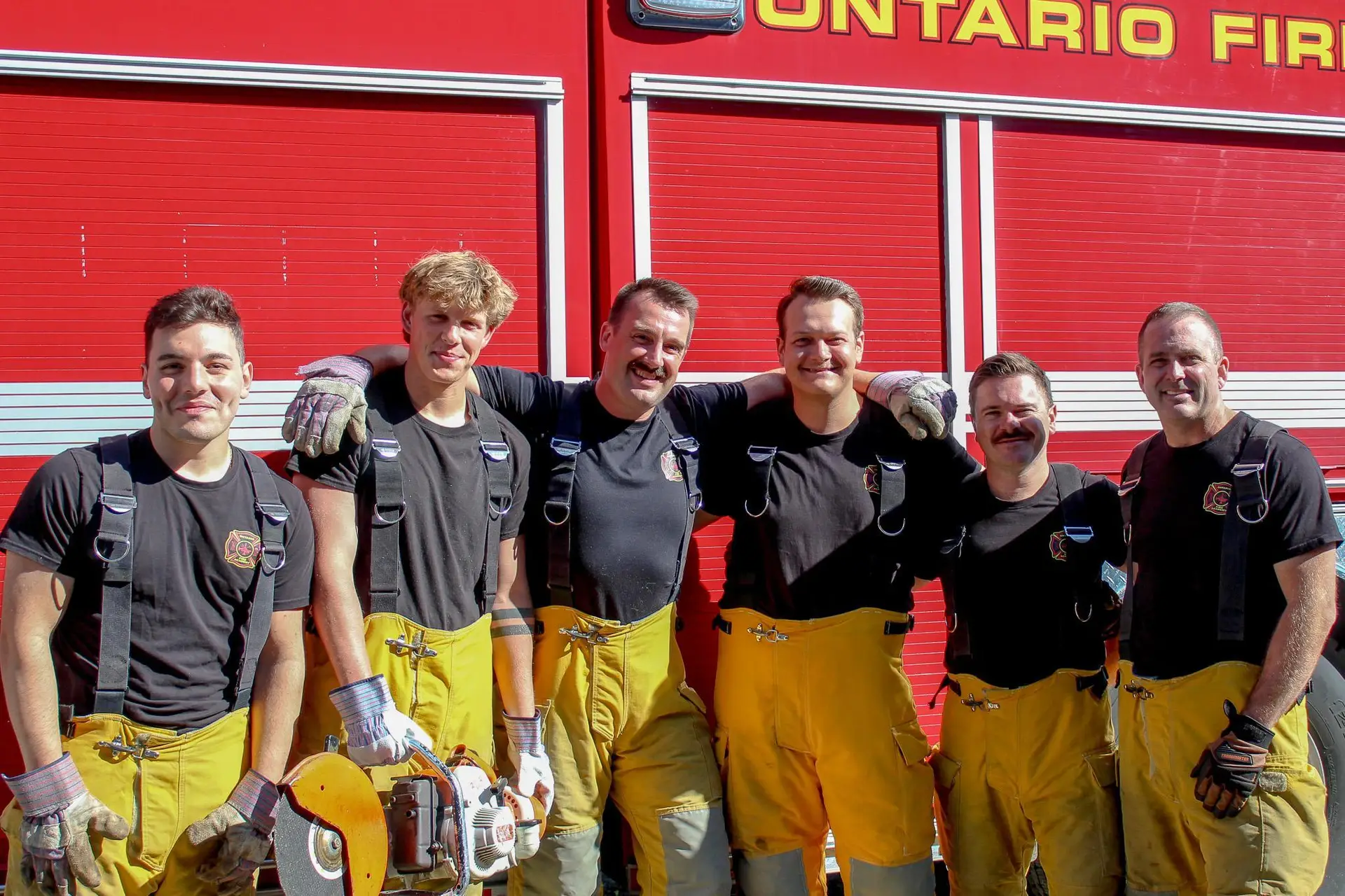 Group of Ontario Fire Academy recruits and instructors posing together