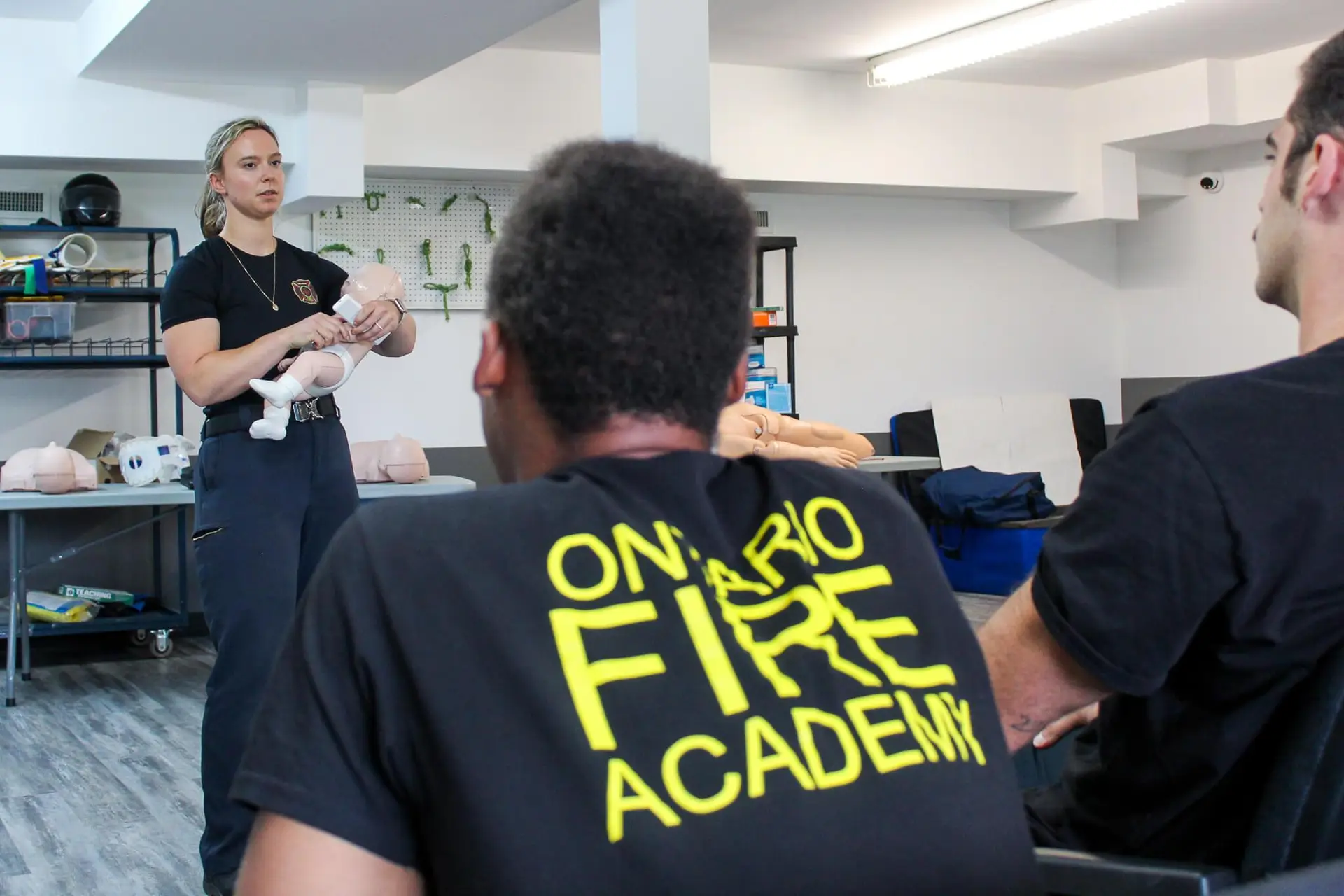 Instructor demonstrating infant CPR technique to students during EFR training